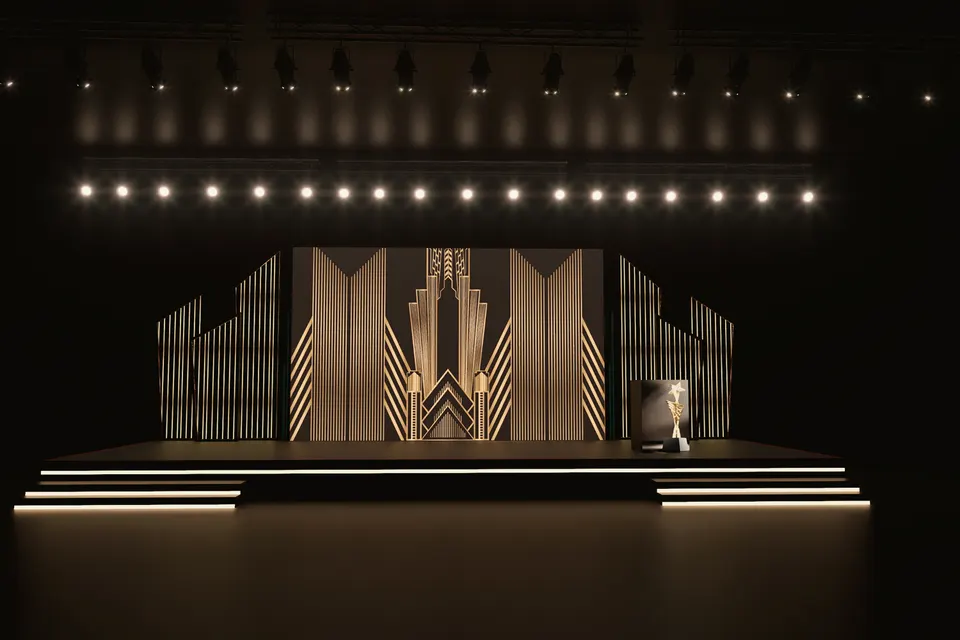 Art-deco gold award stage under a row of spotlights